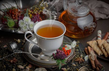 Tea hot drink on old background in composition on the tableの写真素材