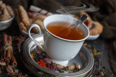 Tea hot drink on old background in composition on the tableの写真素材
