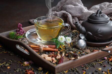 Tea hot drink on old background in composition on the tableの写真素材