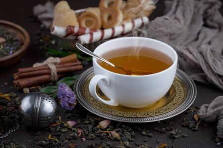Tea in a cup on an old backgroundの写真素材