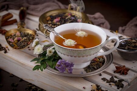 Tea in a cup on an old backgroundの写真素材