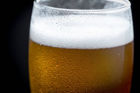 Light beer in a glass on a table in composition with accessories on an old backgroundの写真素材