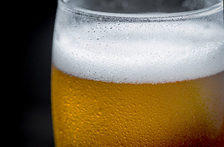 Light beer in a glass on a table in composition with accessories on an old background