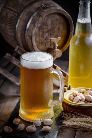 Light beer in a glass on a table in composition with accessories on an old backgroundの写真素材