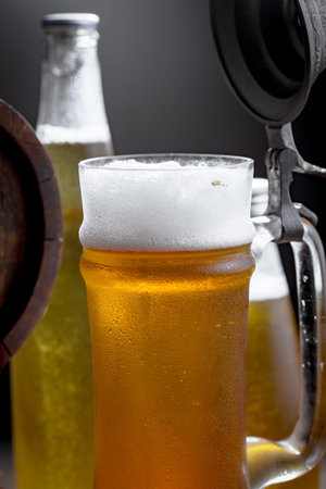 Light beer in a glass on a table in composition with accessories on an old background