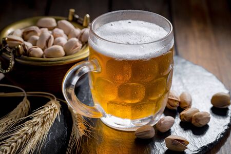 Light beer in a glass on a table in composition with accessories on an old backgroundの写真素材
