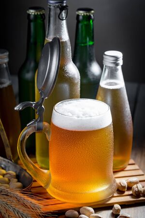 Light beer in a glass on a table in composition with accessories on an old backgroundの写真素材