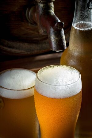 Light beer in a glass on a table in composition with accessories on an old backgroundの写真素材