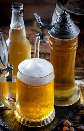 Light beer in a glass on a table in composition with accessories on an old backgroundの写真素材