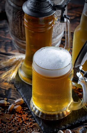 Light beer in a glass on a table in composition with accessories on an old backgroundの写真素材
