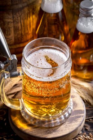 Light beer in a glass on a table in composition with accessories on an old backgroundの写真素材