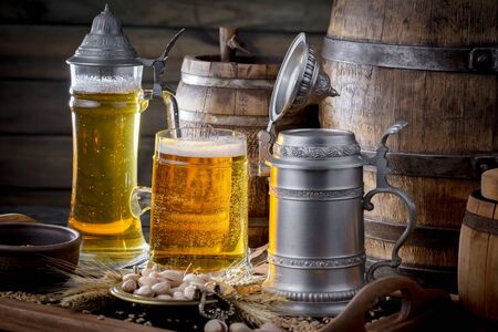 Light beer in a glass on a table in composition with accessories on an old backgroundの写真素材