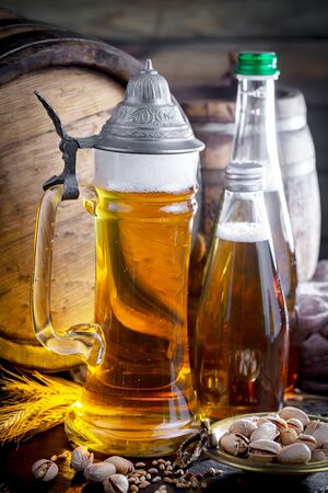 Light beer in a glass on a table in composition with accessories on an old backgroundの写真素材