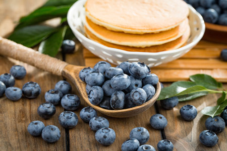 Pancakes with blueberries on a wooden background. Selective focus.の写真素材