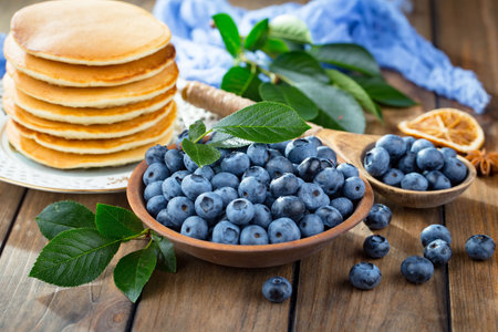 Blueberry pancakes with fresh berries on a wooden background. Selective focus.の写真素材