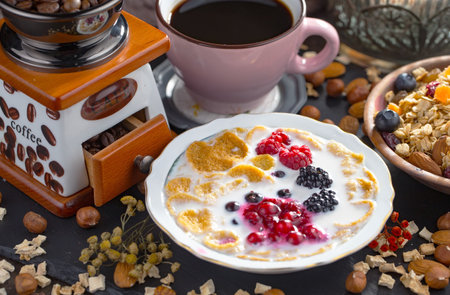Breakfast with oatmeal, berries and coffee on a wooden backgroundの写真素材