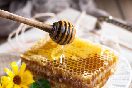 Honeycombs with honey on a wooden background. Selective focusの写真素材