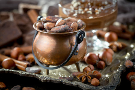 Cacao beans in a copper pot and chocolate. Selective focusの写真素材