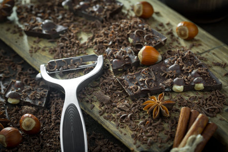 Dark chocolate in a composition with cocoa beans and nuts, on an old background.の写真素材
