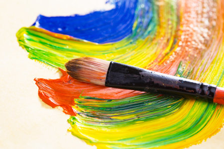 Paint brushes with colorful paint on a white background, close-upの写真素材
