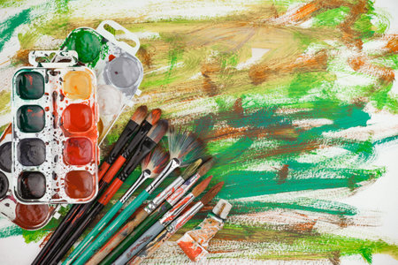 Paint brushes and paints on a white background, close-upの写真素材