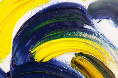 Abstract background of oil paint on a palette with yellow and blue colors