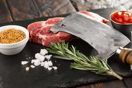 Raw meat with spices in a composition with kitchen accessories.の写真素材