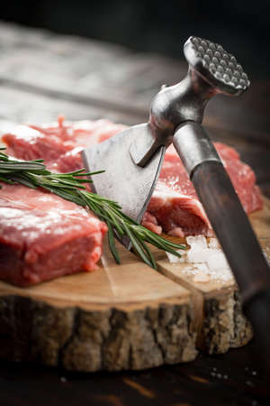 Raw meat with spices in a composition with kitchen accessories.の写真素材