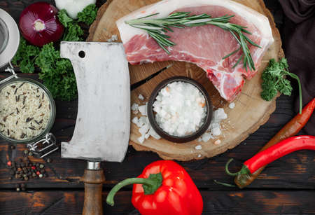 Raw meat with spices in a composition with kitchen accessories.の写真素材