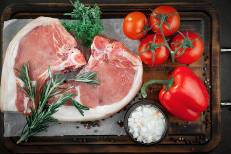 Raw meat with spices in a composition with kitchen accessories.