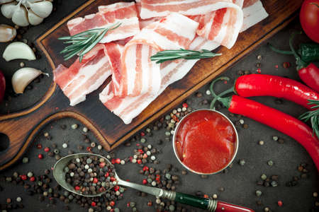 Raw meat with spices in a composition with kitchen accessories.の写真素材