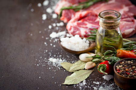 Raw meat with spices in a composition with kitchen accessories.の写真素材