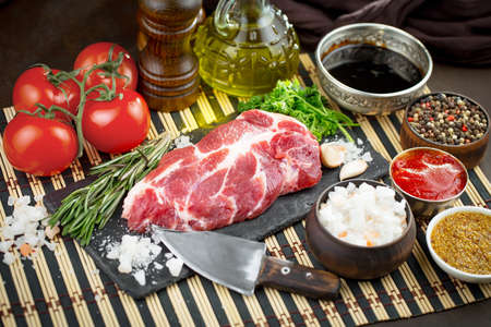 Raw meat with spices in a composition with kitchen accessories.の写真素材