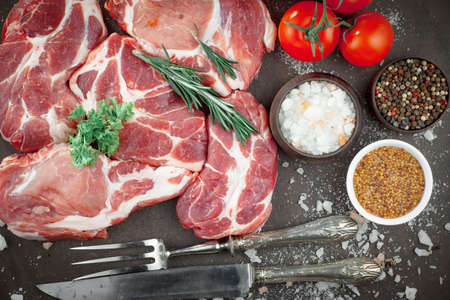 Raw meat with spices in a composition with kitchen accessories.の写真素材
