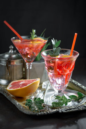 Refreshing summer alcoholic cocktail with crushed ice and citrus fruits