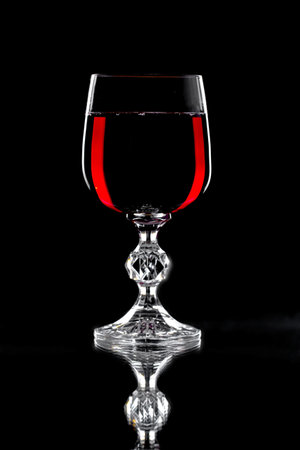Glasses of wine on a black background.