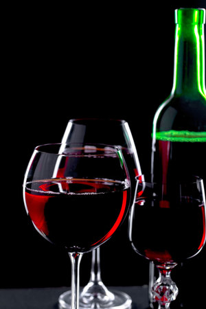 Glasses of wine on a black background.
