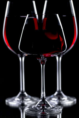 Glasses of wine on a black background.の写真素材