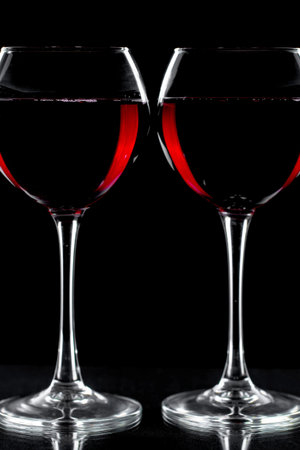 Glasses of wine on a black background.