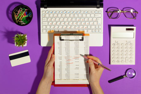 Female hands with items for doing business on a bright colored background