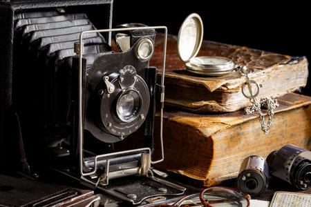 Vintage camera and old books on a black background. High quality photoの写真素材