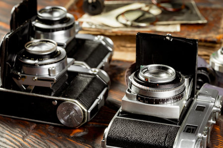Vintage camera on a wooden background. Close-up view.