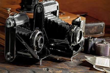 Old camera on a dark wooden background. Close-up, selective focus.の写真素材