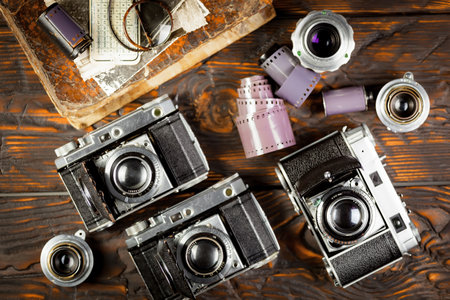 Old film camera on a wooden background. Top view. Flat lay.の写真素材