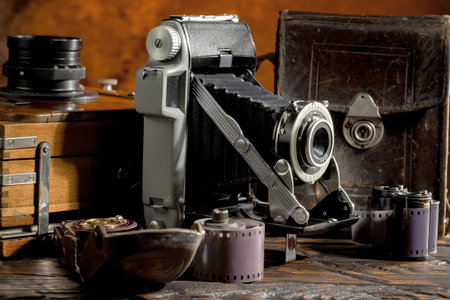 Old camera on an old wooden table. Vintage photo camera on an old wooden table.の写真素材
