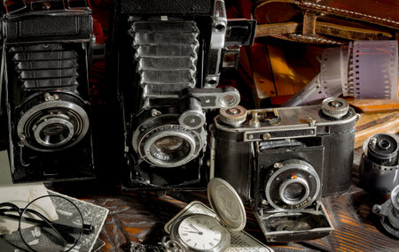 Old camera on the background of old photos. Vintage photo camera.の写真素材