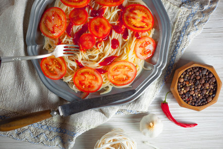 Spaghetti with tomato sauce and spices on a white wooden background.の写真素材