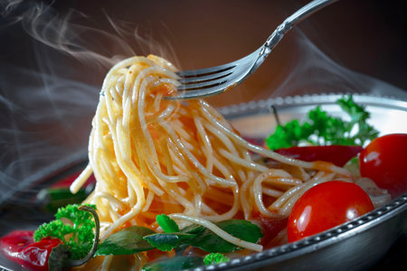 Spaghetti with tomato sauce and parsley on a black background.の写真素材