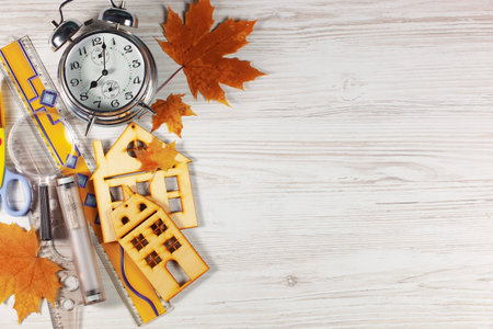 School supplies and alarm clock on wooden background. Back to school. Copy space.の写真素材