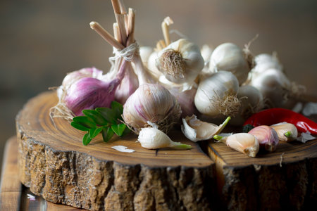 Garlic on a wooden background. Selective focus. Food.の写真素材